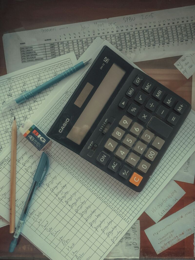 A calculator resting on a pile of papers