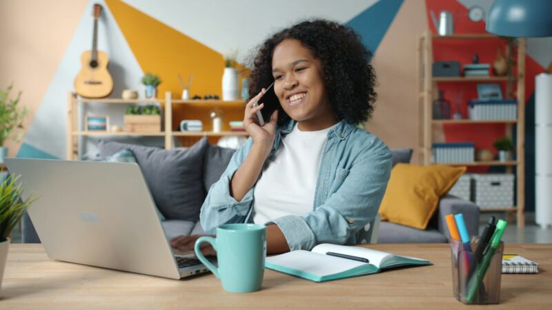 A woman on a phone call at her desk