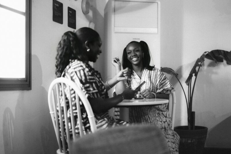 Two women talking over coffee at a table
