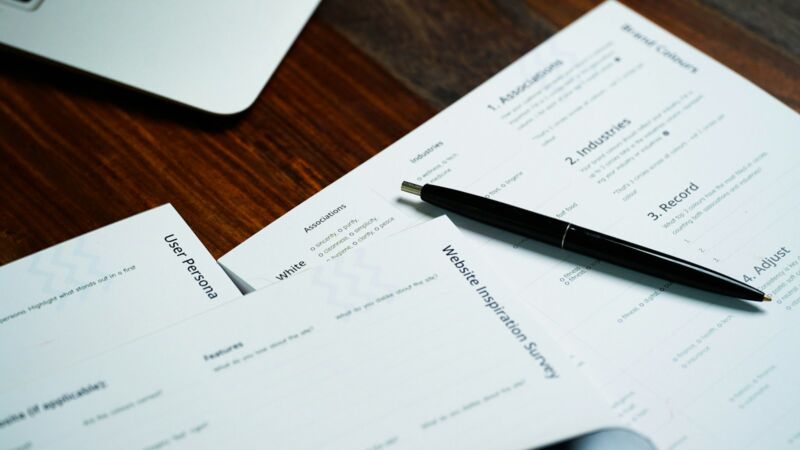 A pen resting on a stack of paperwork