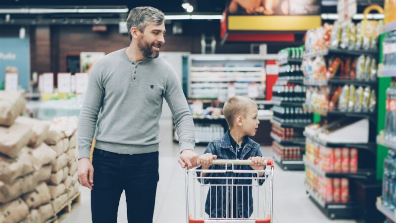 A father and son shopping together for groceries