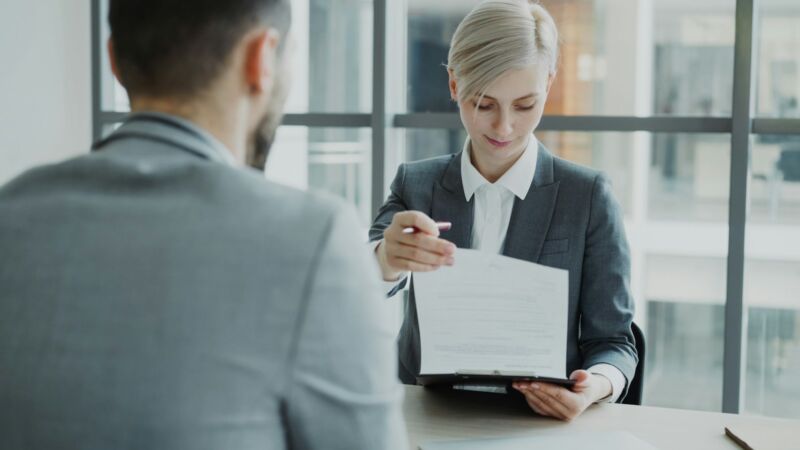 A professional reviewing a document with a client