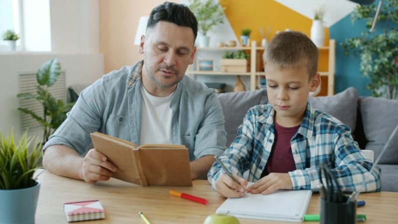 A father reading with his young child