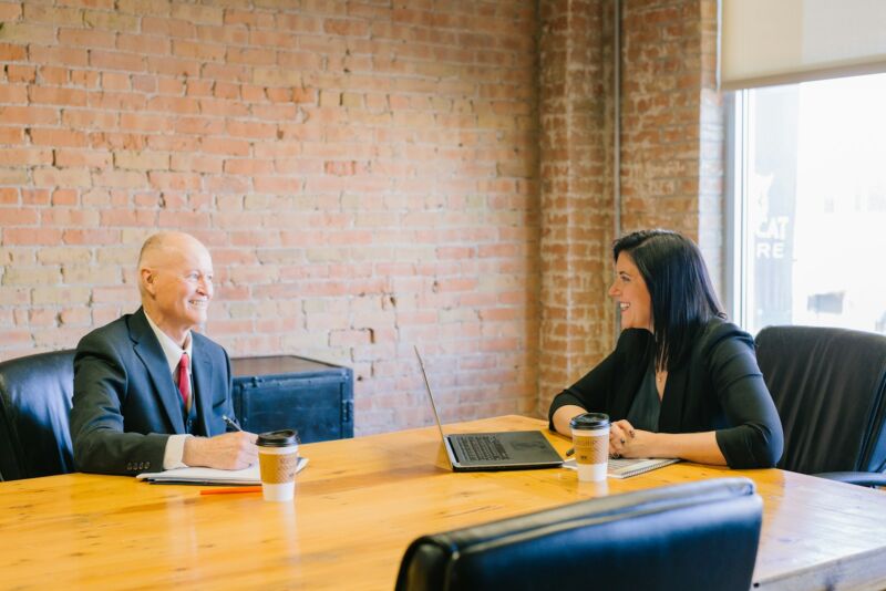 A man and woman in a calm conversation in an office