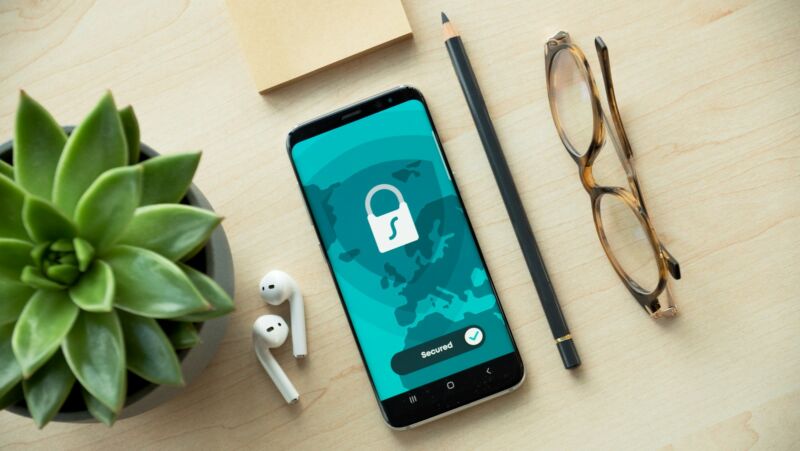 A smartphone showing a lock icon on a wooden desk