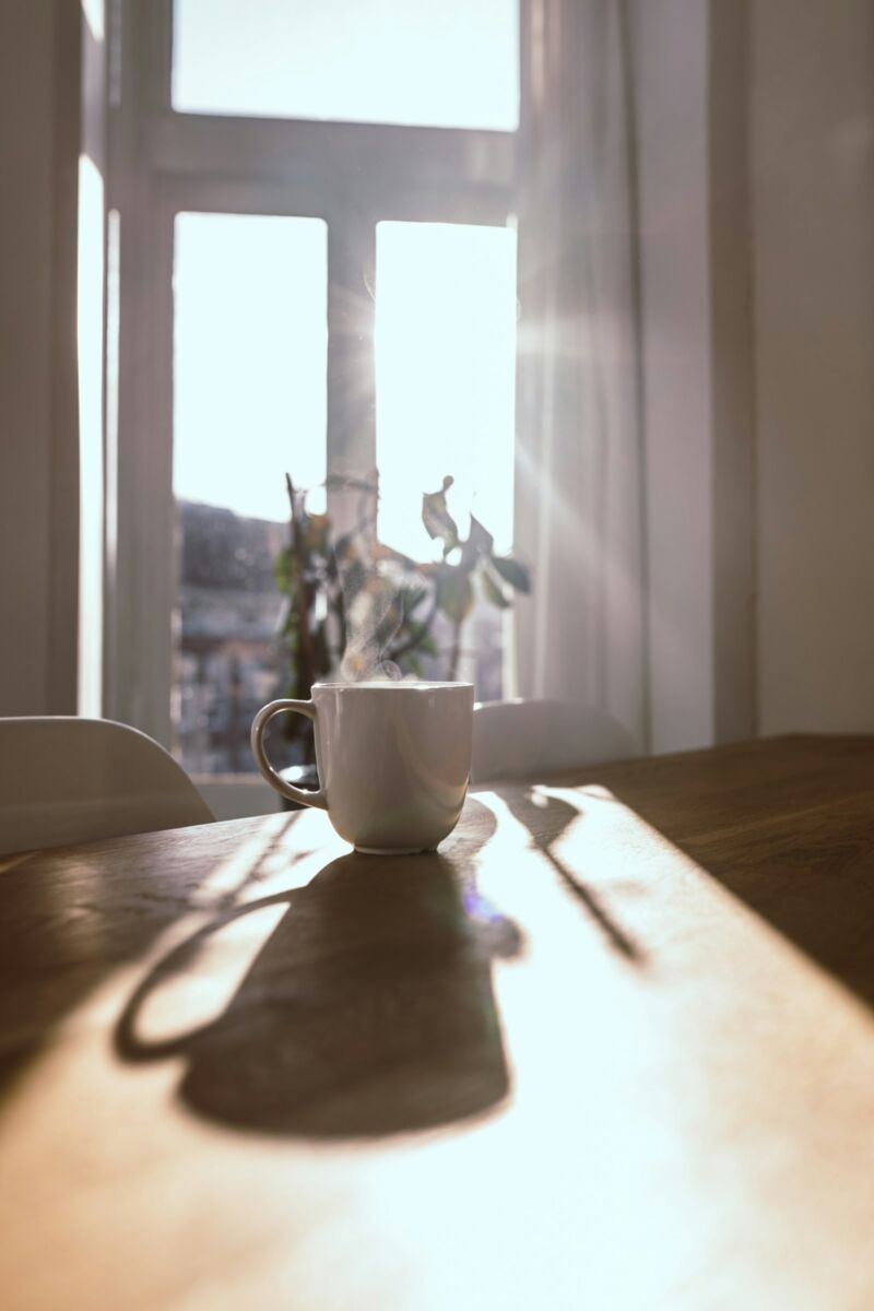 A mug on a table in morning window light