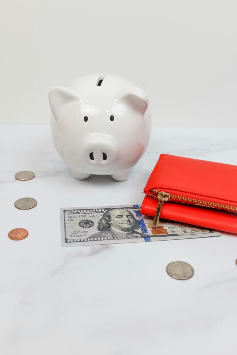 A piggy bank surrounded by coins and cash
