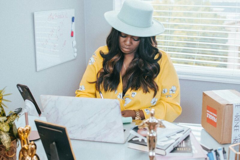A woman working on her own at a home office desk