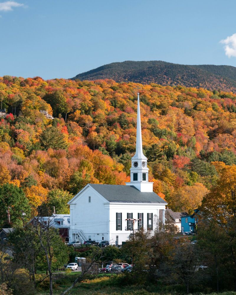 A white church amid fall foliage in Stowe, Vermont