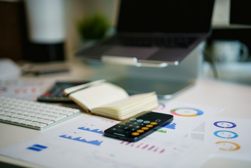Printed financial charts and statements on a desk